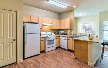 Kitchen with wood cabinets and white appliances3